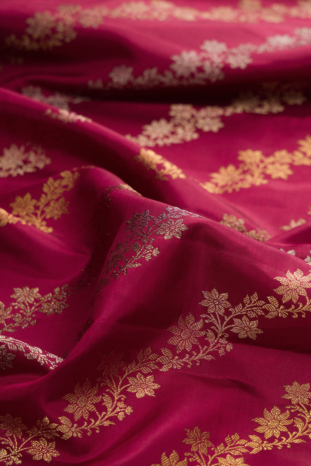 Close up of Pure Silk Maroon Kanchipuram Saree with Zari Brocade on the body and Zari Border.  displaying folds
