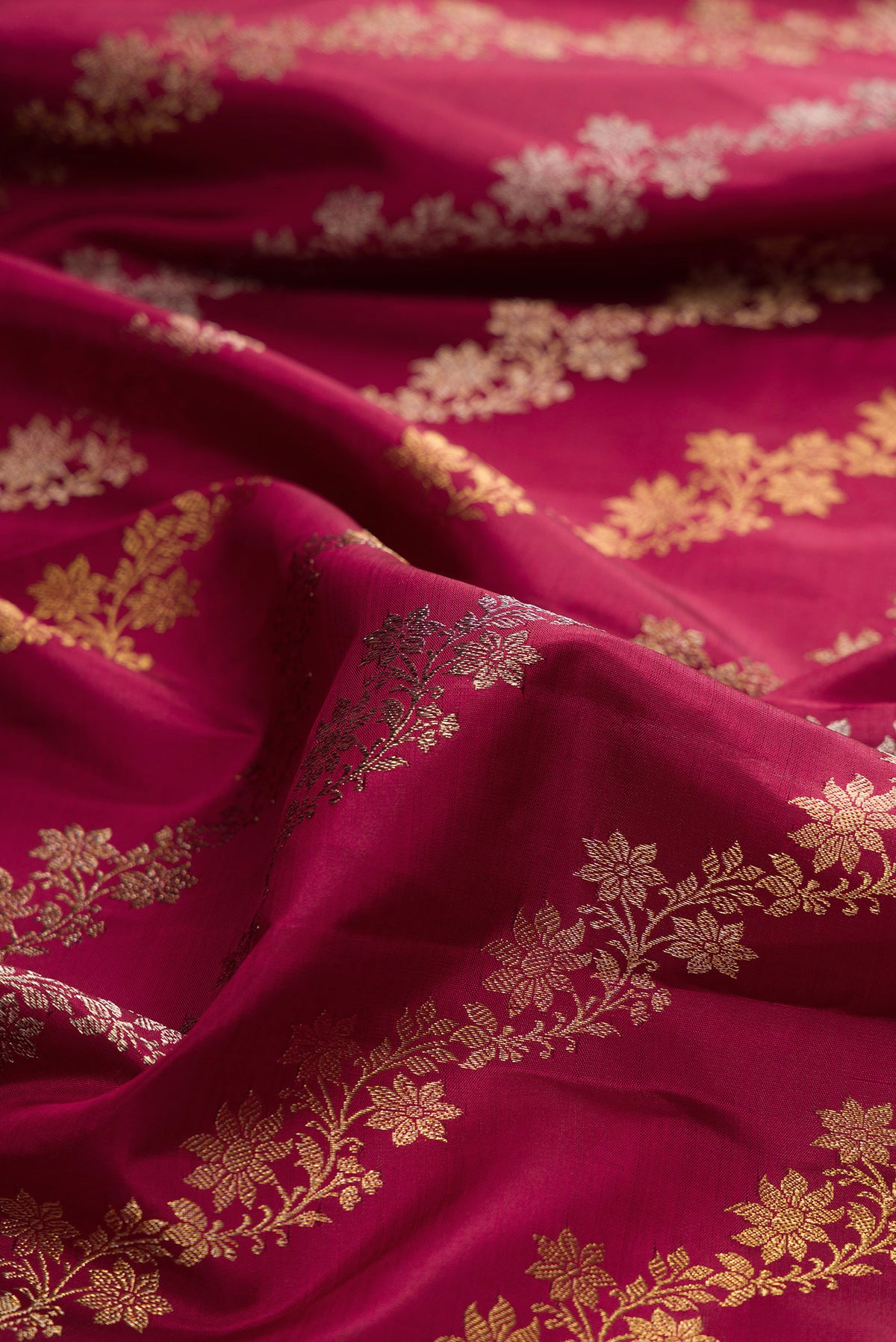 Close up of Pure Silk Maroon Kanchipuram Saree with Zari Brocade on the body and Zari Border.  displaying folds