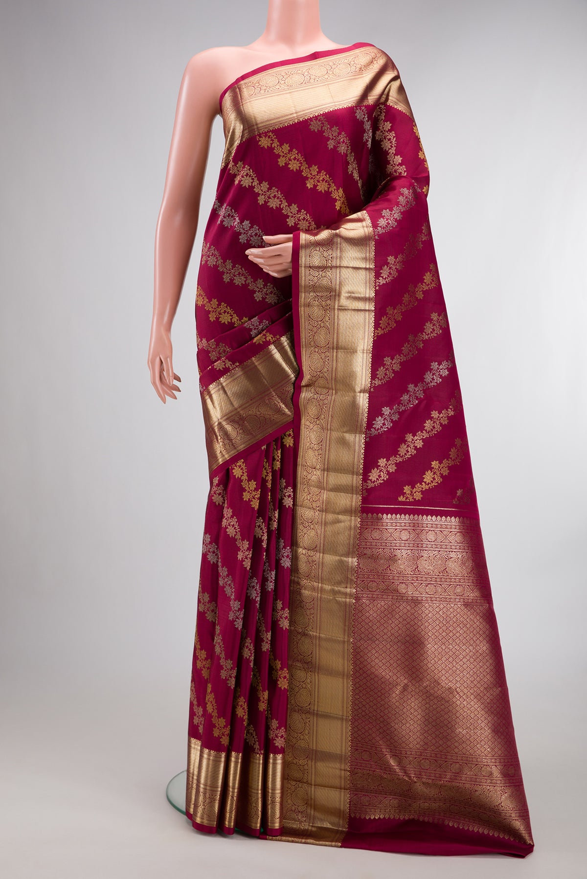 Pure Silk Maroon Kanchipuram Saree with Zari Brocade on the body and Zari Border.  displayed on a mannequin