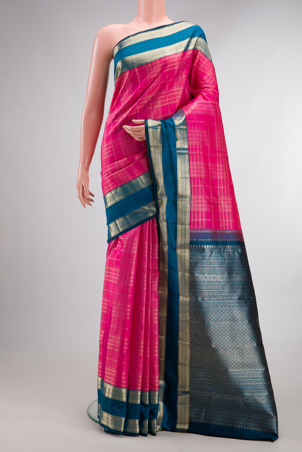 Pure Silk Pink Kanchipuram Saree with Checked design on the body and Zari Border.  displayed on a mannequin