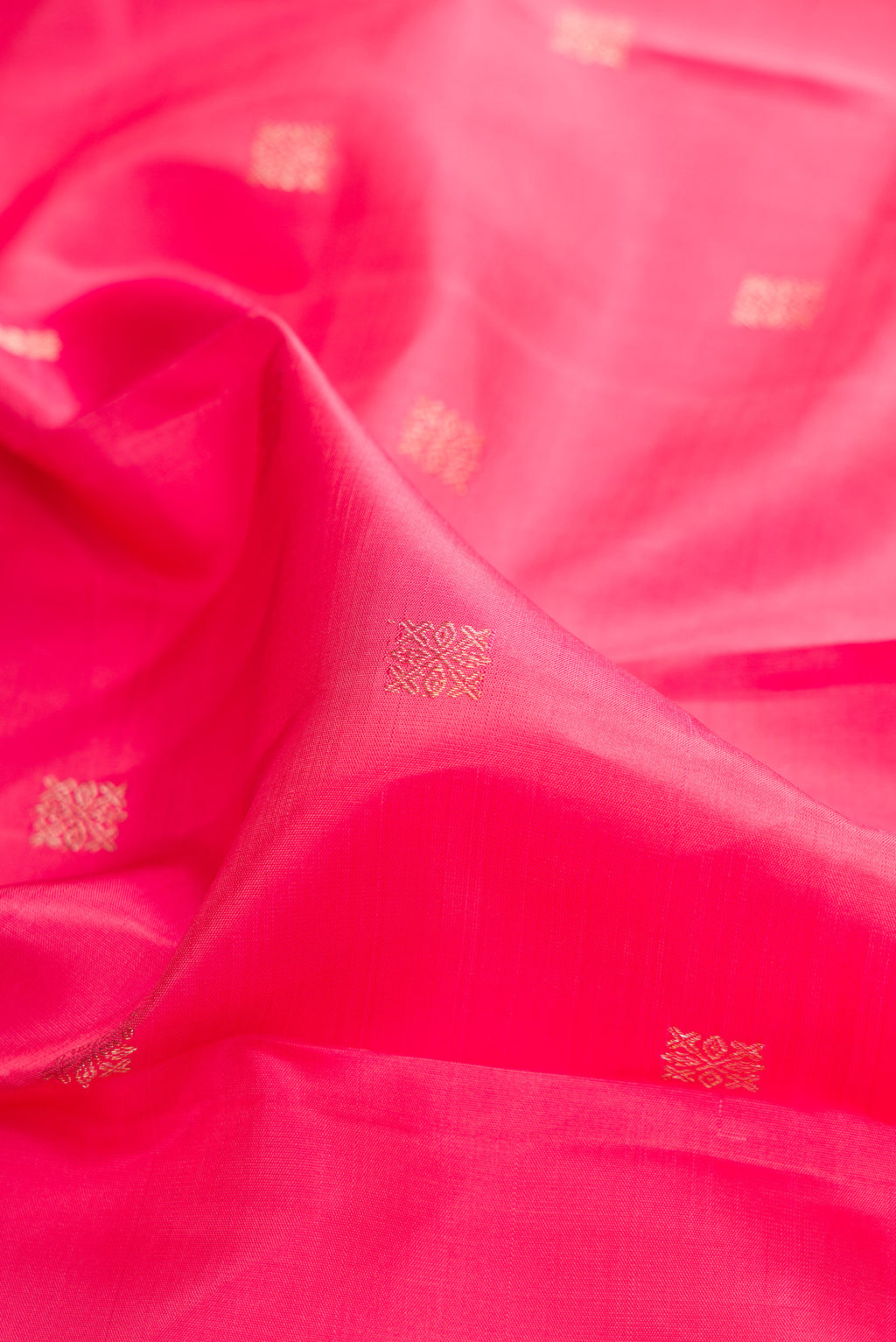 Close up of Pure Silk Pink Dual Tone Kanjivaram Saree with Zari Butta on the body and Fancy Border.  displaying folds