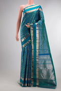 Pure Silk Peacock Blue Dual Tone Kanchipuram Saree with Checked design on the body and Zari Border.  displayed on a mannequin