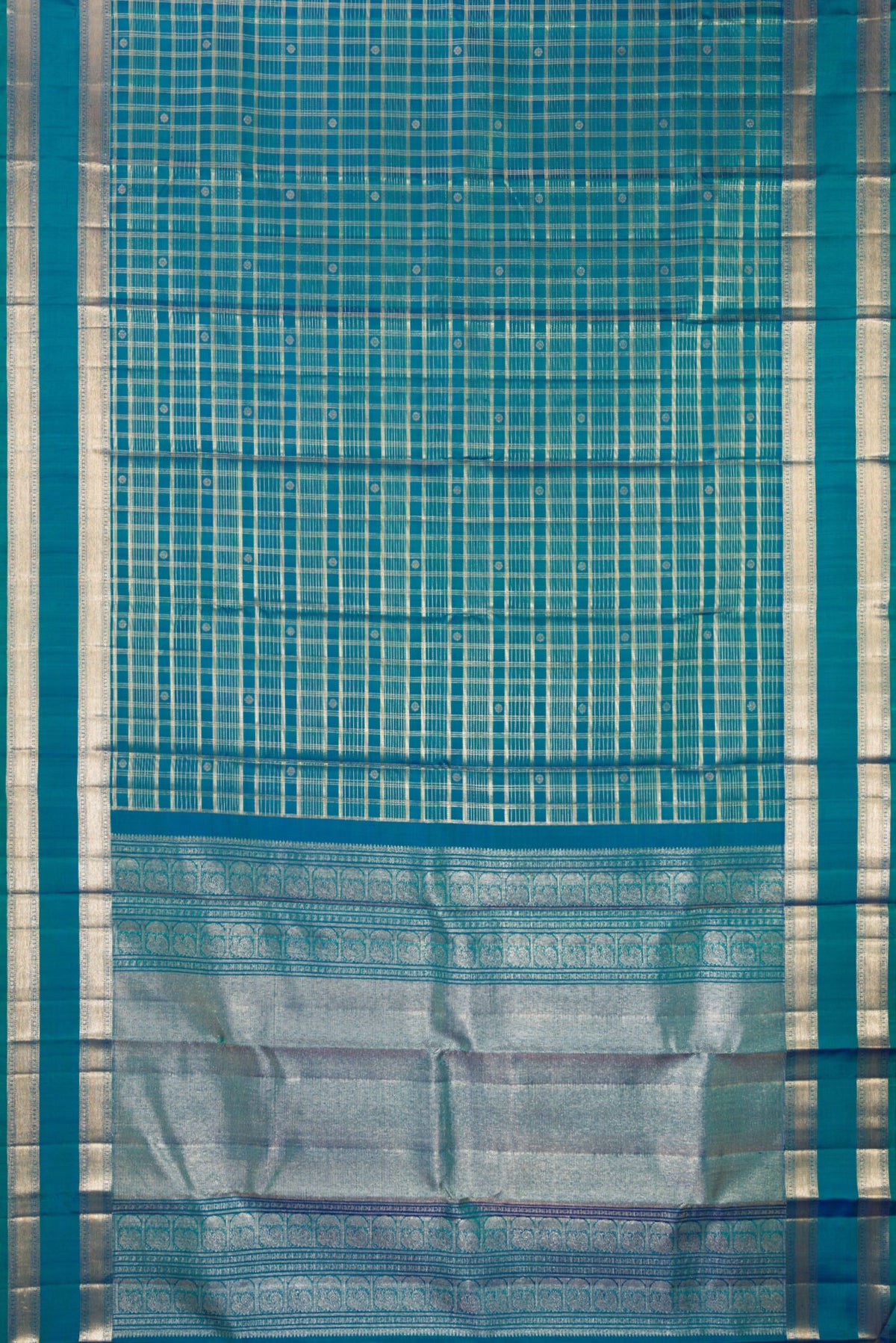 Flat view of Pure Silk Peacock Blue Dual Tone Kanchipuram Saree with Checked design on the body and Zari Border. 