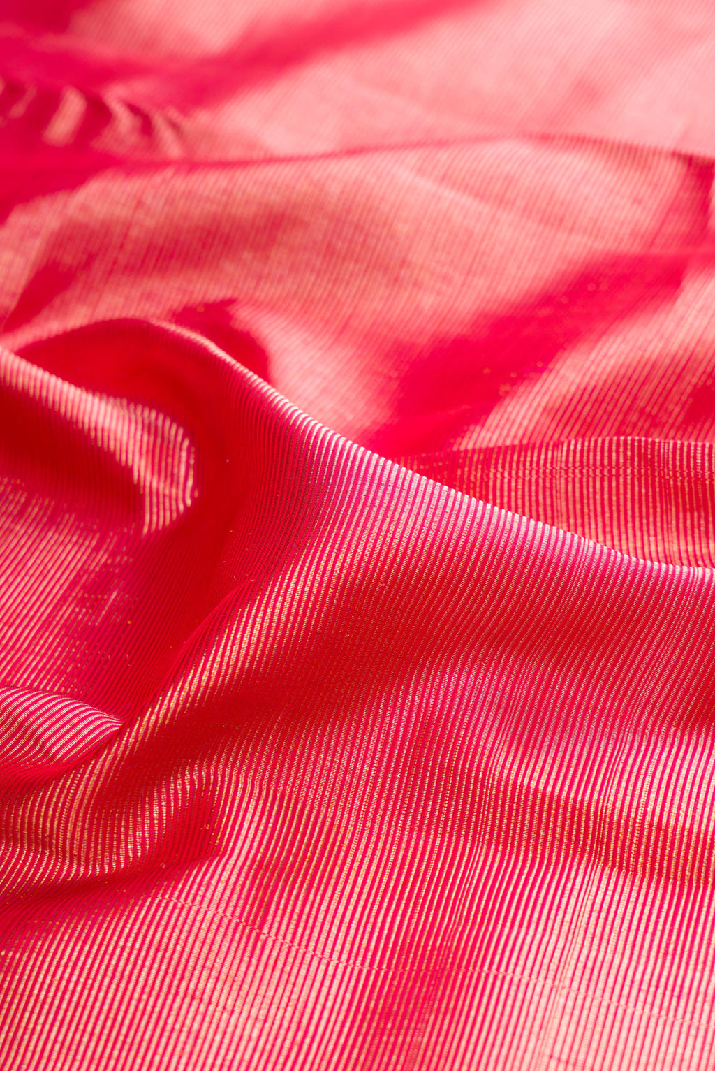 Close up of Pure Silk Pink Dual Tone Kanjivaram Saree with Zari Brocade on the body and Fancy Border.  displaying folds