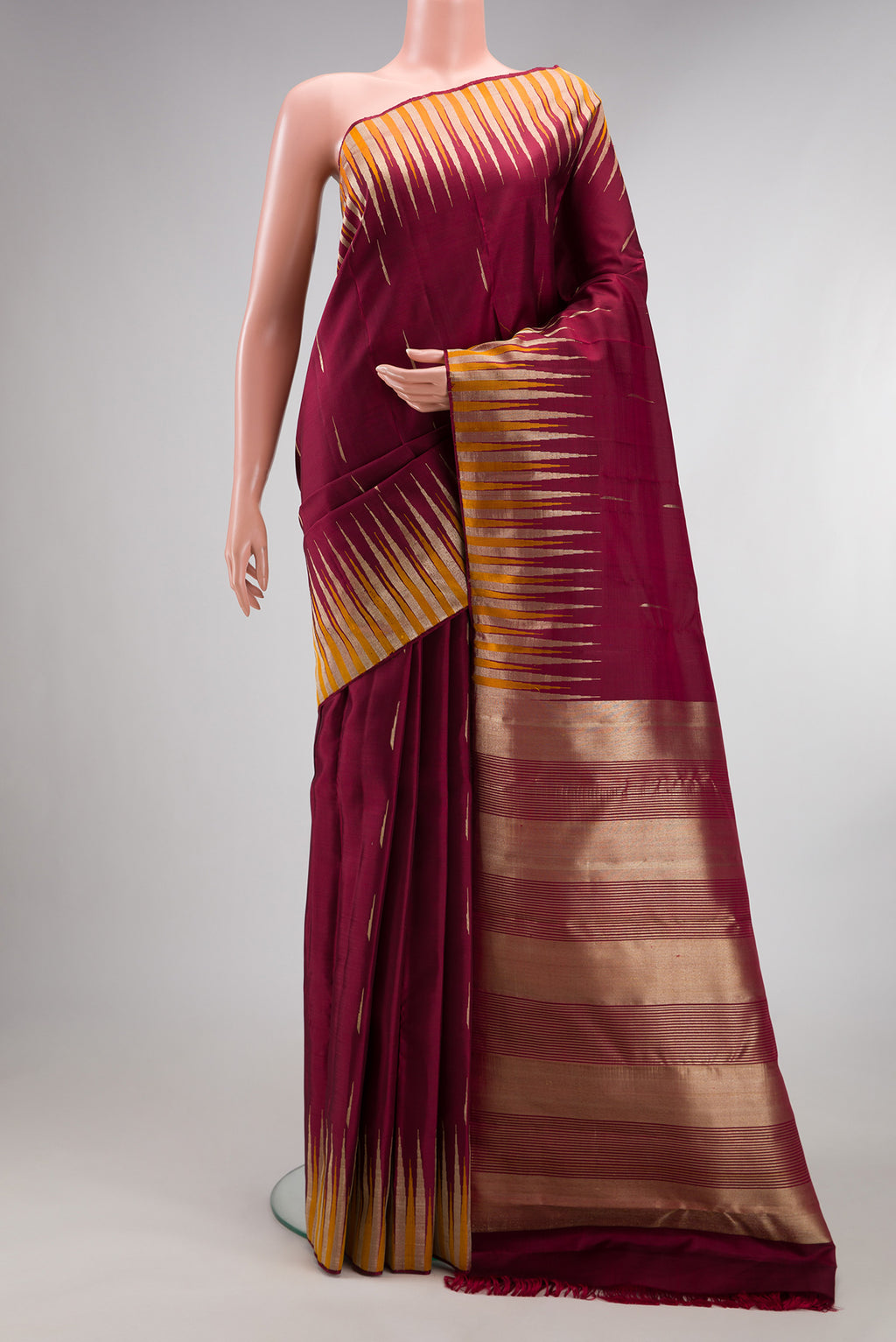 Pure Silk Maroon Kanjivaram Saree with Zari Butta on the body and Fancy Border.  displayed on a mannequin