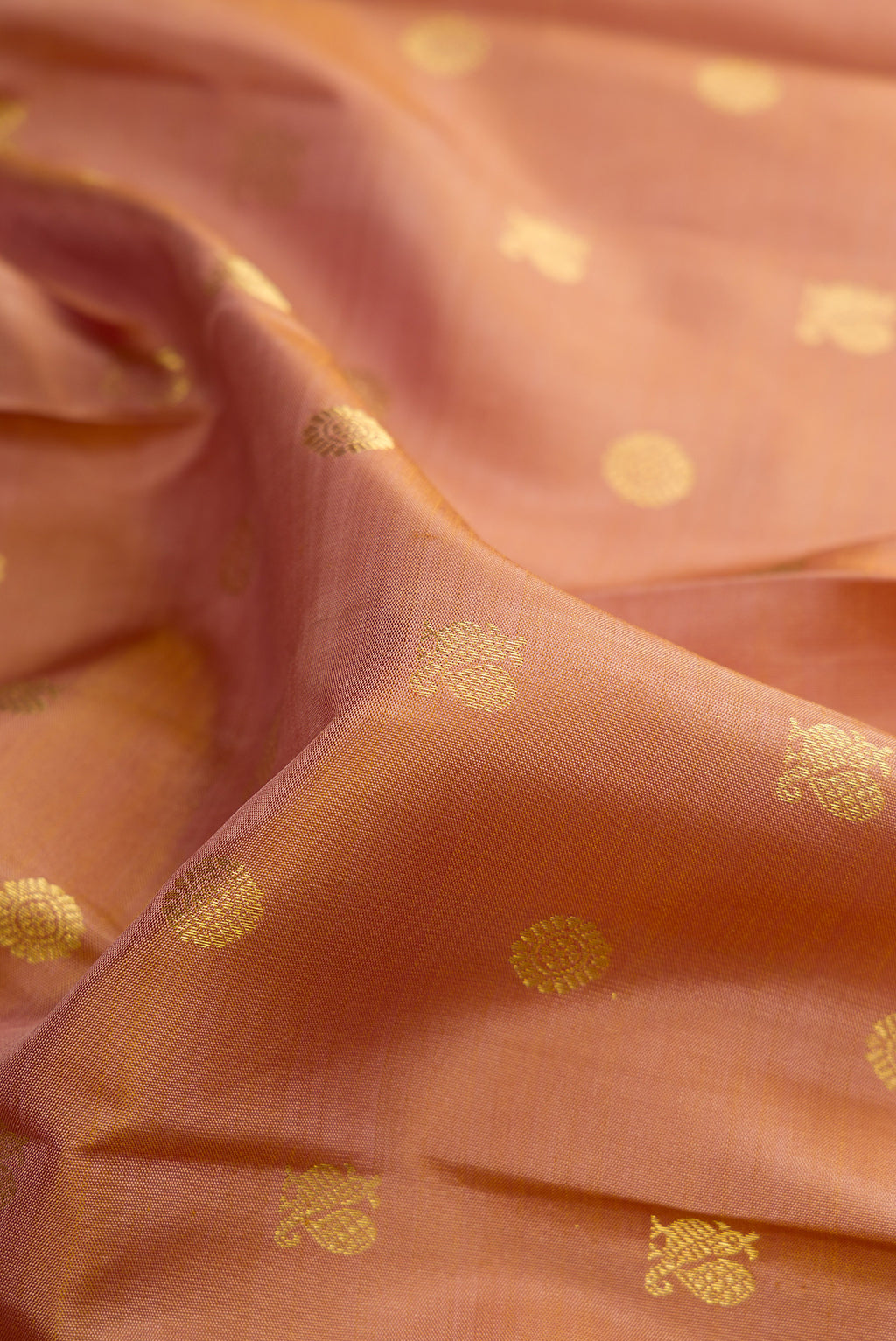 Close up of Pure Silk Caramel Kanjivaram Saree with Zari Butta on the body and Zari Border.  displaying folds