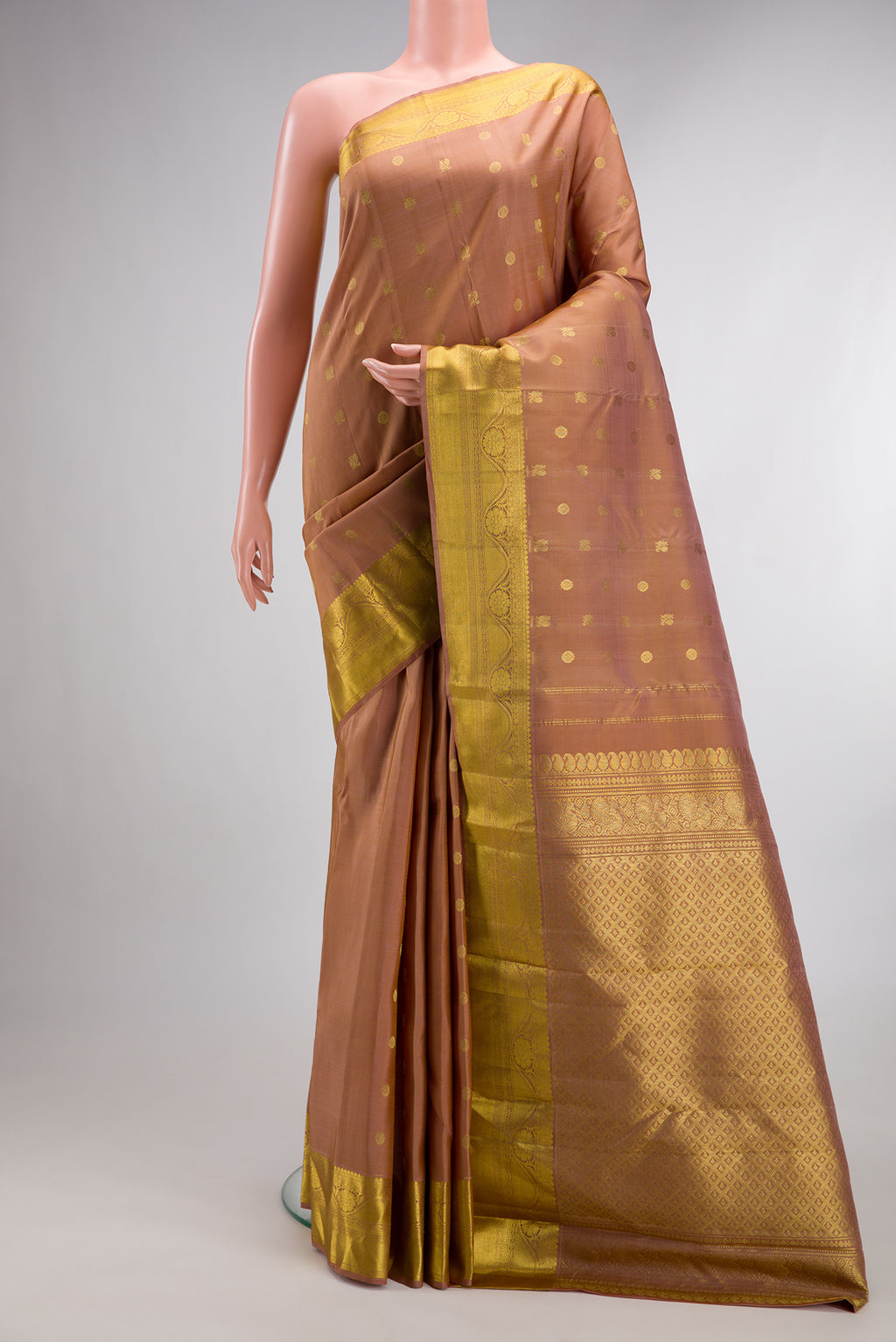 Pure Silk Caramel Kanjivaram Saree with Zari Butta on the body and Zari Border.  displayed on a mannequin