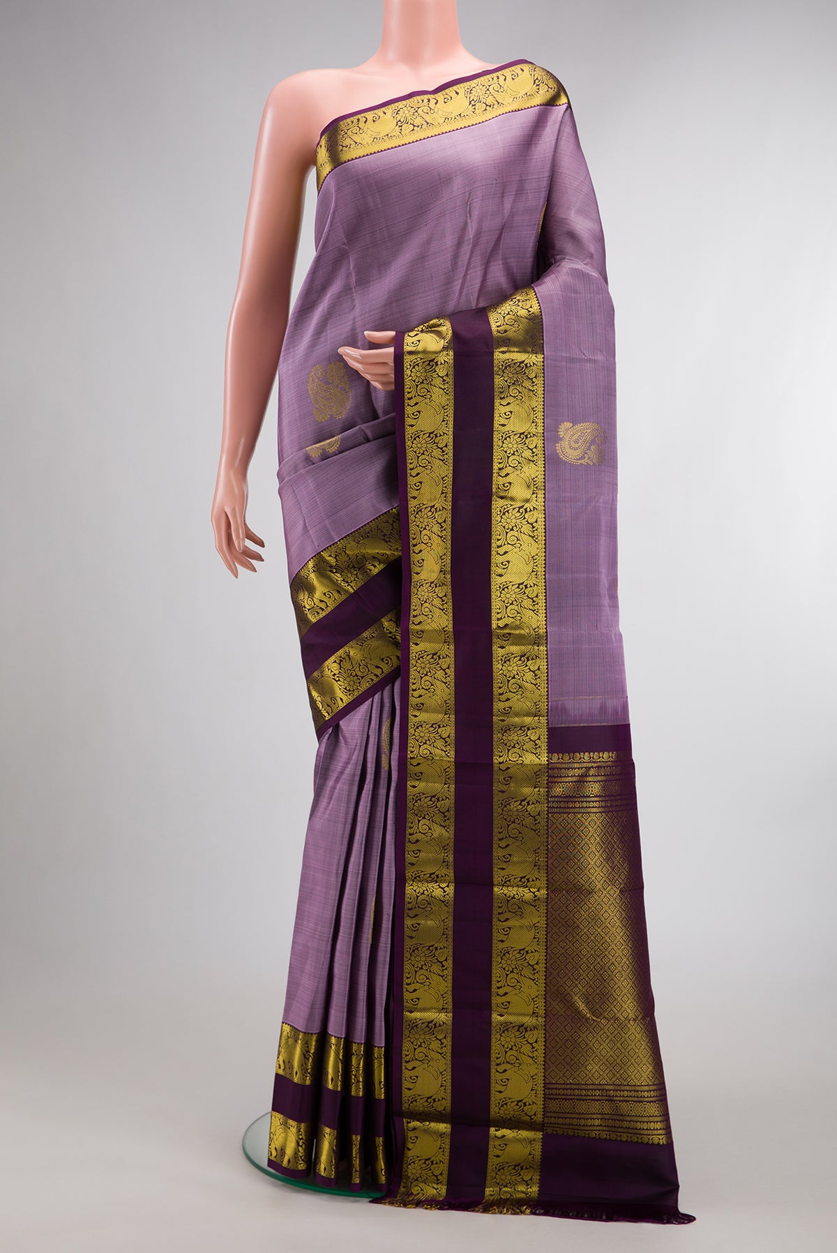 Pure Silk Lavender Kanchipuram Saree with Zari Butta on the body and Zari Border.  displayed on a mannequin