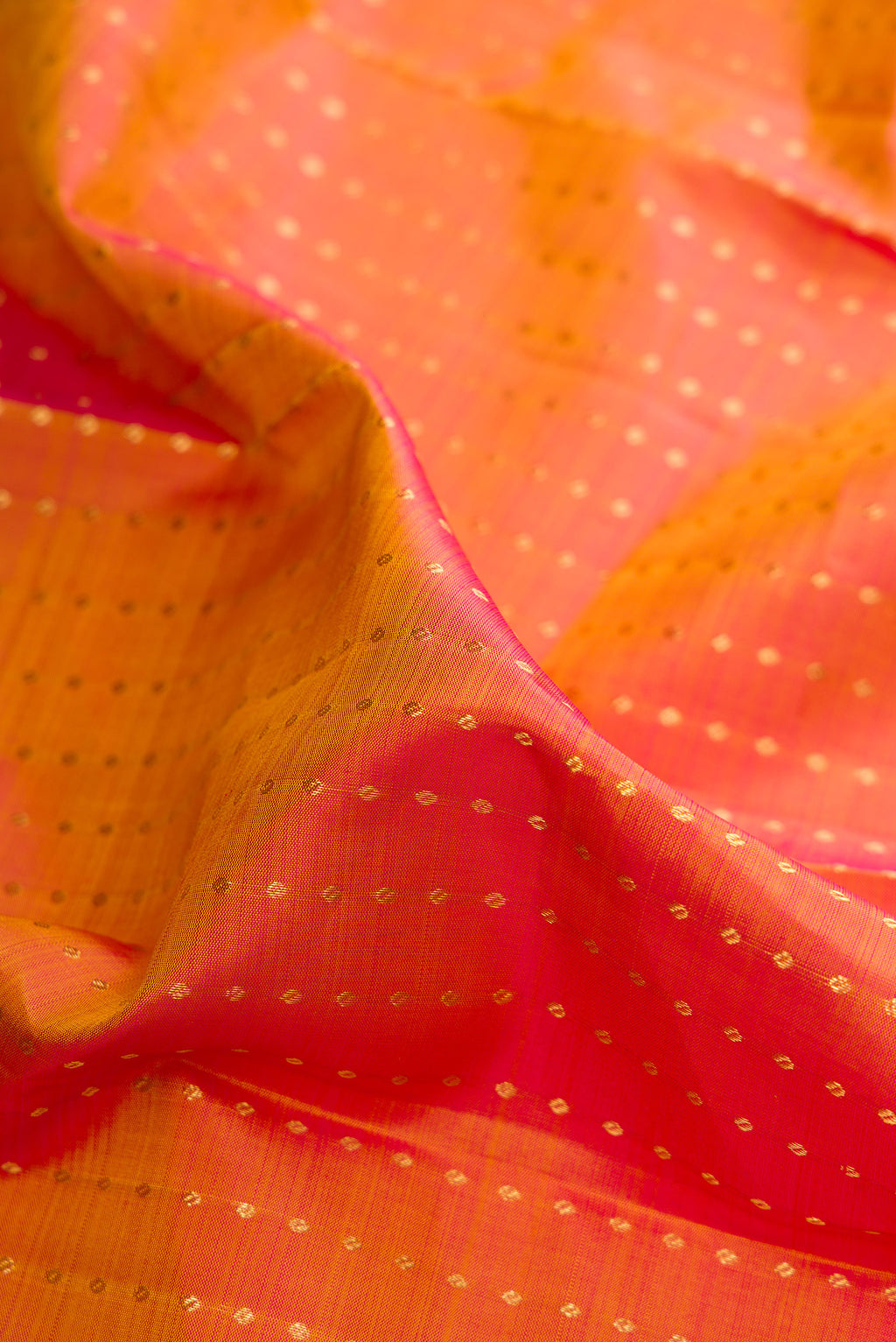 Close up of Pure Silk Mustard Dual Tone Kanchipuram Saree with Zari Butta on the body and Zari Border.  displaying folds