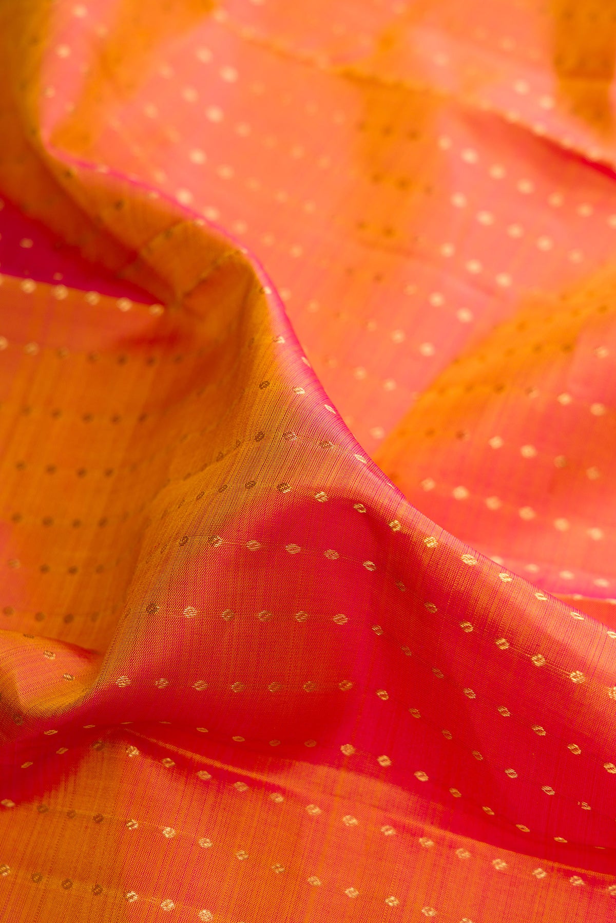 Close up of Pure Silk Mustard Dual Tone Kanchipuram Saree with Zari Butta on the body and Zari Border.  displaying folds