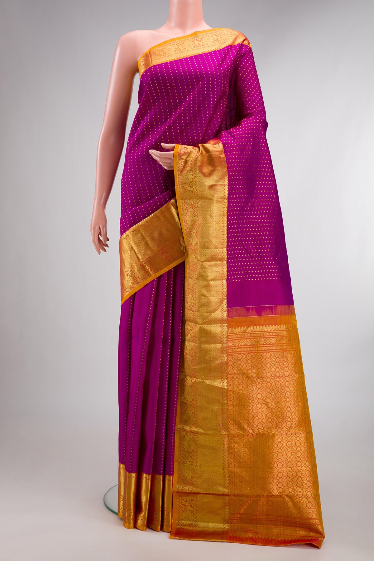 Pure Silk Magenta Kanchipuram Saree with Zari Butta on the body and Zari Border.  displayed on a mannequin