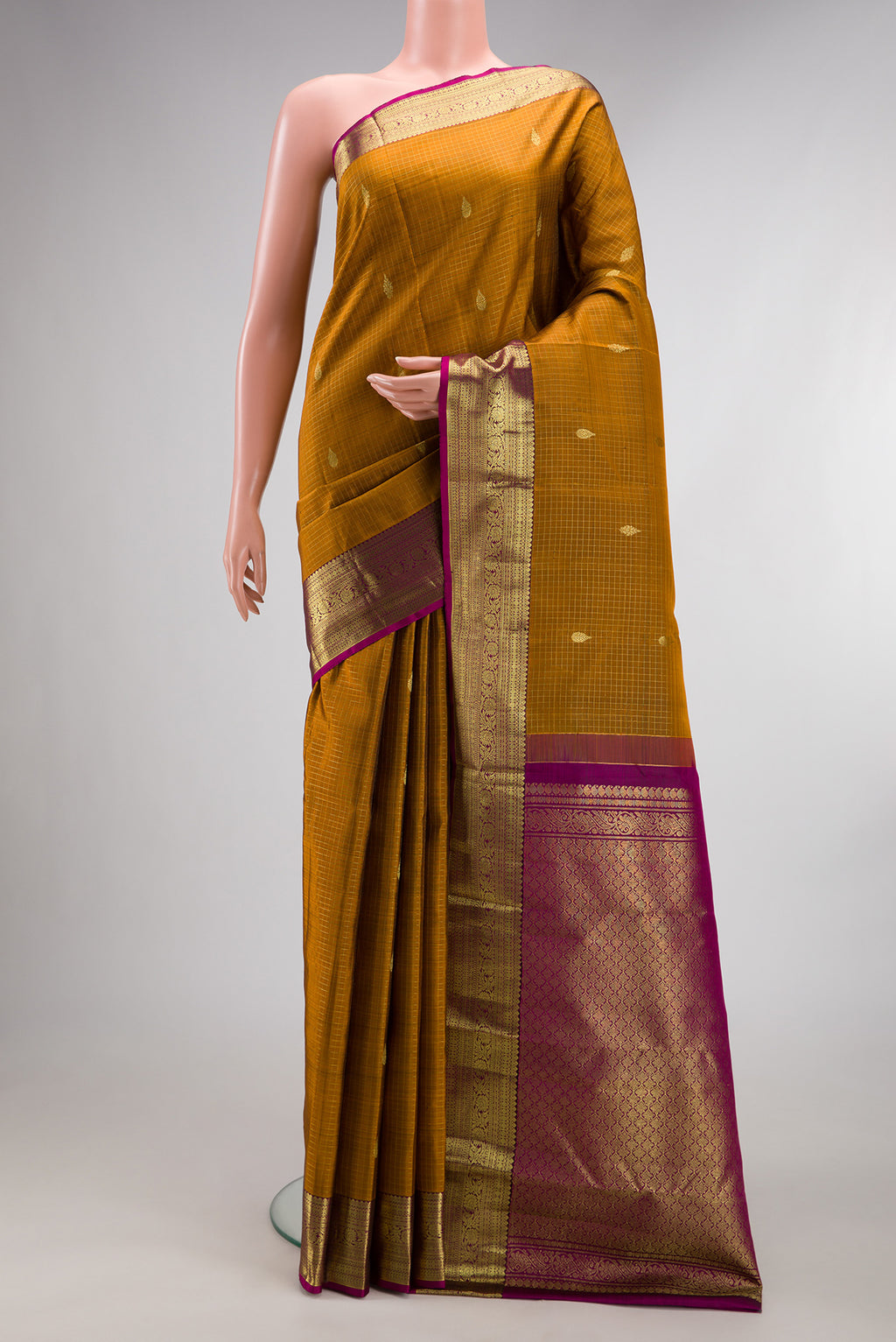 Pure Silk Mustard Kanchipuram Saree with Checked design on the body and Zari Border.  displayed on a mannequin