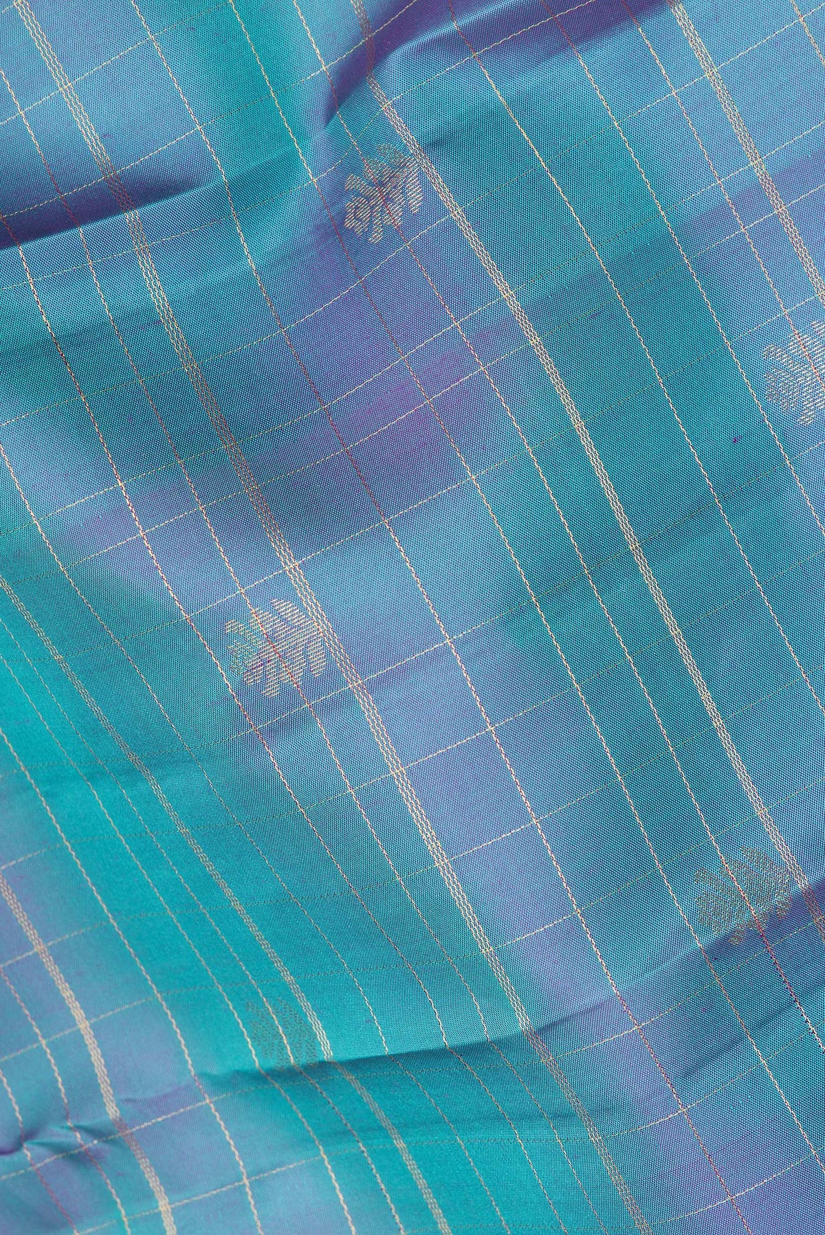 Close up of Pure Silk Peacock Blue Dual Tone Kanchipuram Saree with Checked design on the body and Zari Border.  displaying folds
