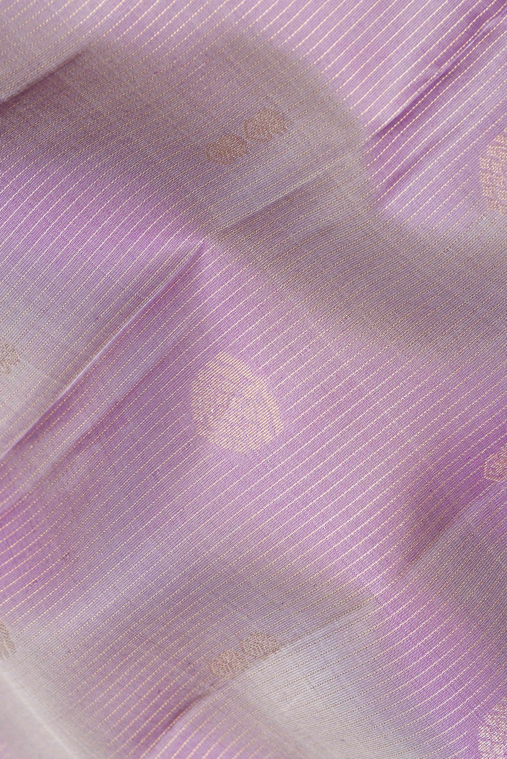 Close up of Pure Silk Purple Dual Tone Kanchipuram Saree with Zari Butta on the body and Zari Border.  displaying folds