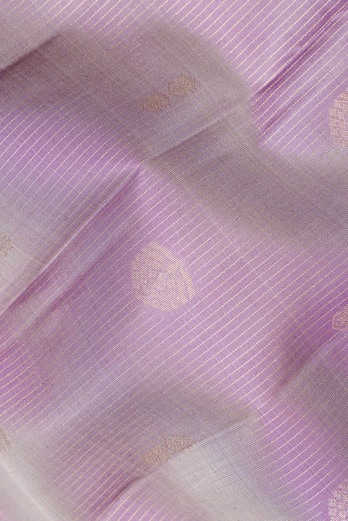 Close up of Pure Silk Purple Dual Tone Kanchipuram Saree with Zari Butta on the body and Zari Border.  displaying folds