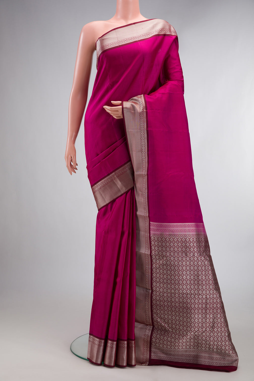 Pure Silk Dark Pink Kanchipuram Saree with Plain Body and Thread Border.  displayed on a mannequin