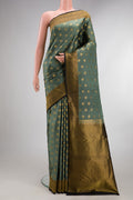 Pure Silk Olive Green Kanchipuram Saree with Zari Butta on the body and Zari Border.  displayed on a mannequin