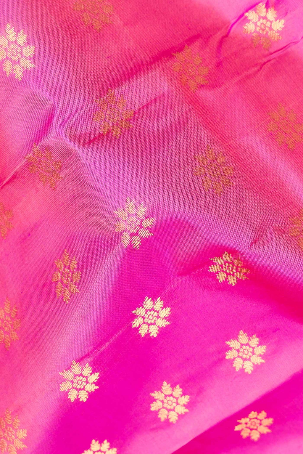 Close up of Pure Silk Pink Kanchipuram Saree with Zari Butta on the body and Zari Border.  displaying folds