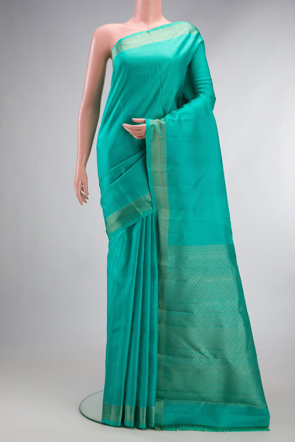 Pure Silk Sea Green Kanjivaram Saree with Stripes on the body and Thread Border.  displayed on a mannequin