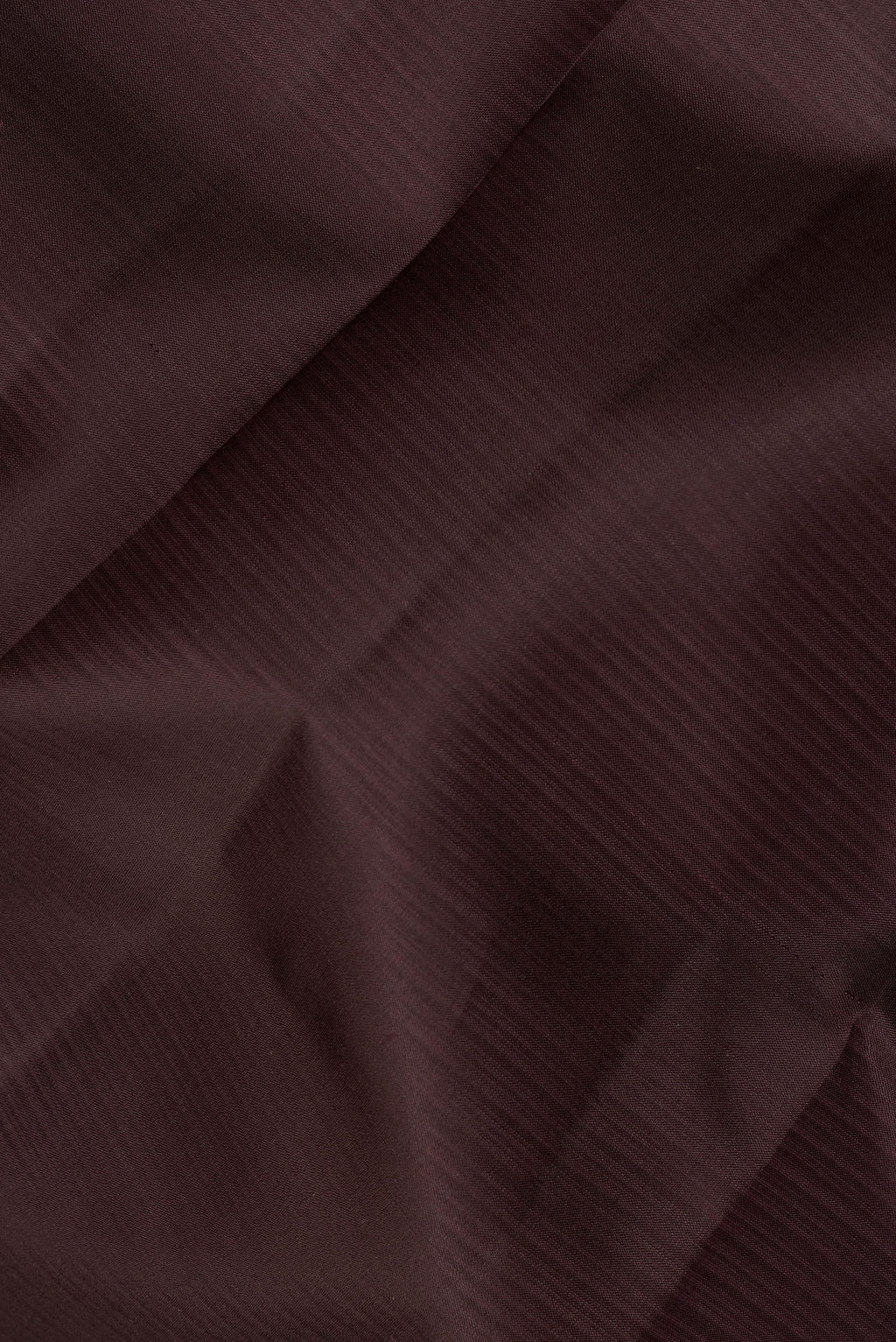 Close up of Pure Silk Coffee Brown Dual Tone Kanjivaram Saree with Plain Body and Thread Border.  displaying folds