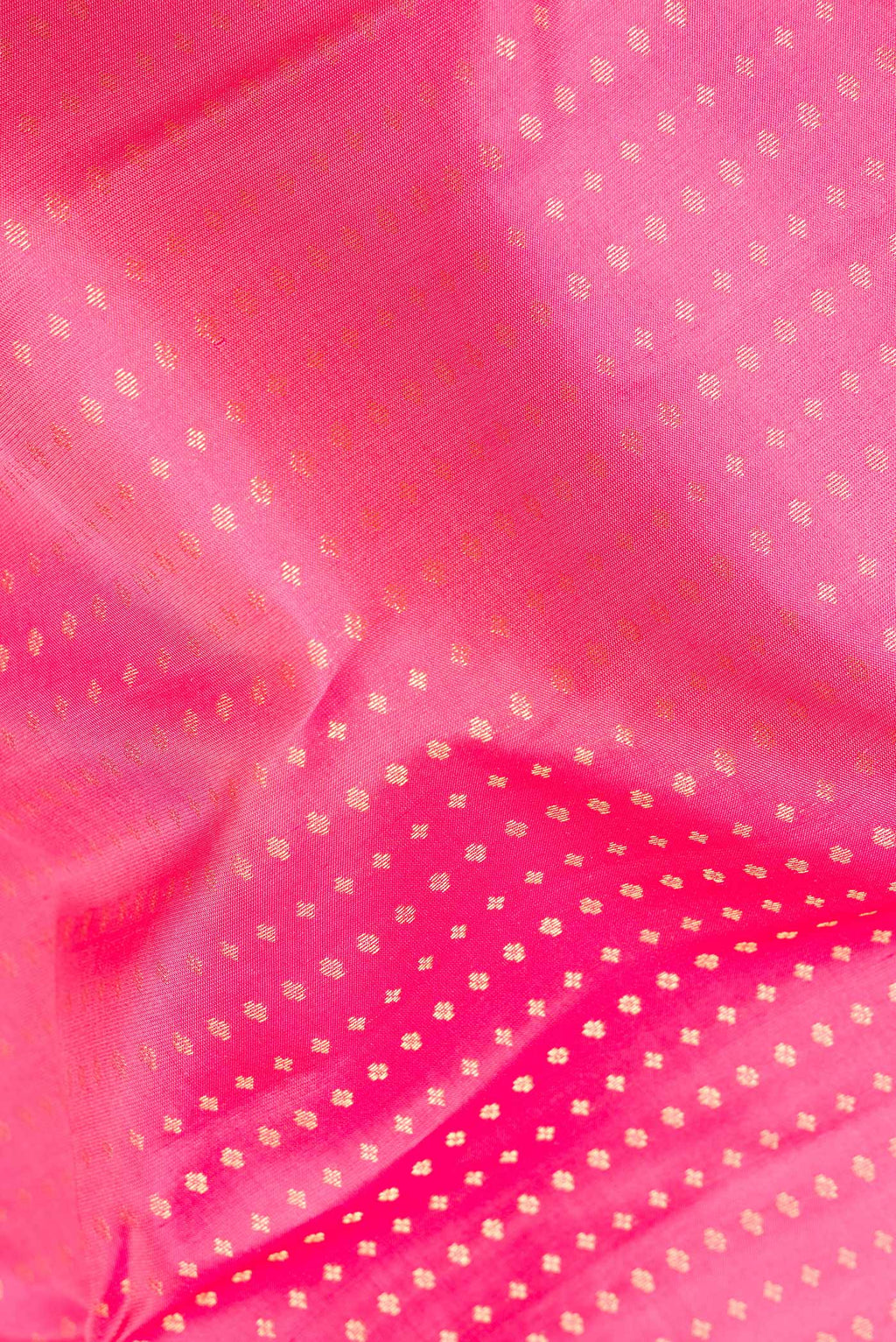 Close up of Pure Silk Pink Kanchipuram Saree with Zari Butta on the body and Zari Border.  displaying folds