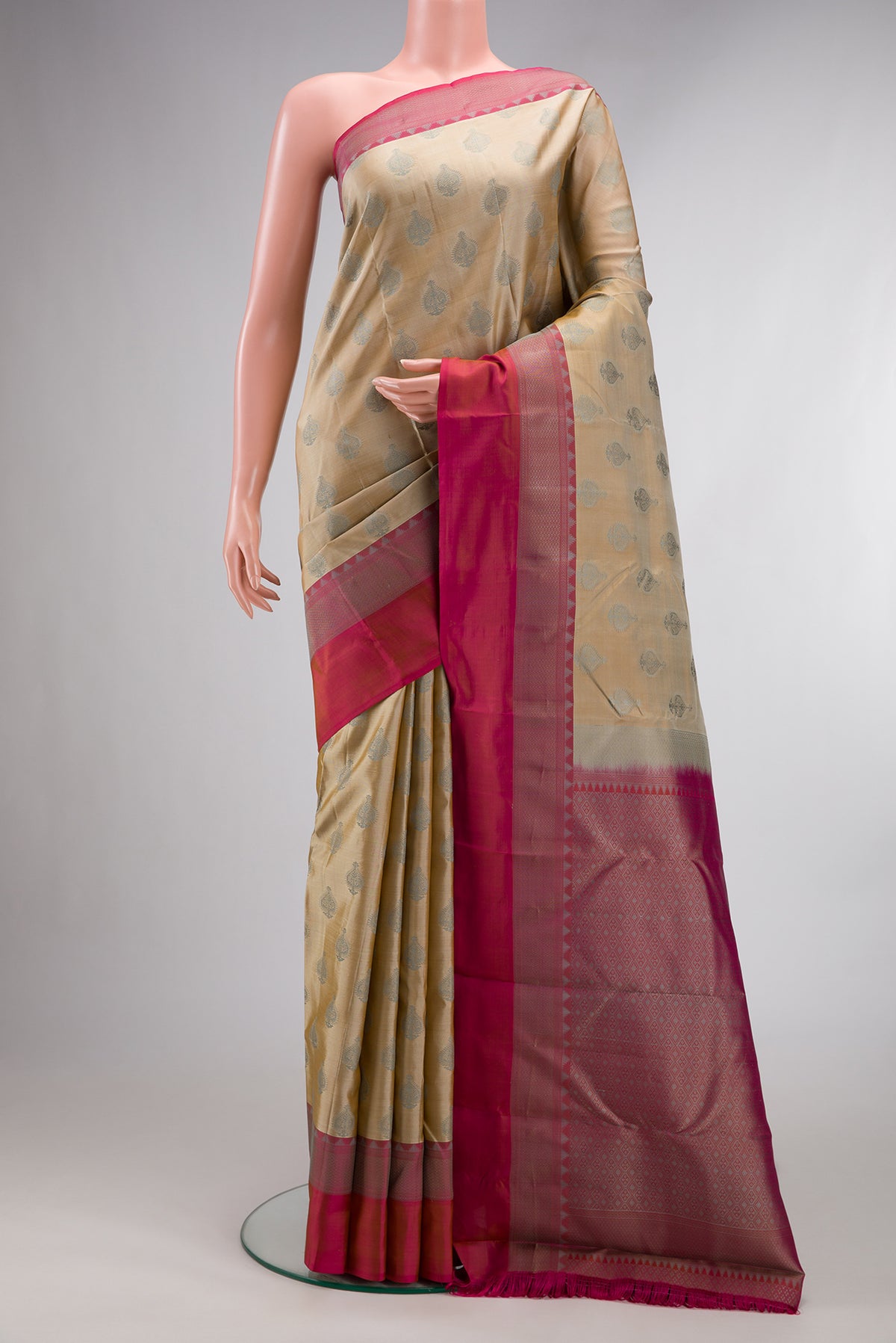 Pure Silk Beige Kanchipuram Saree with Thread Butta on the body and Thread Border.  displayed on a mannequin