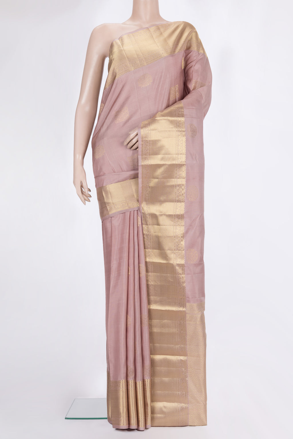 Pure Silk Rose Gold Kanchipuram Saree with Zari Butta on the body and Zari Border.  displayed on a mannequin