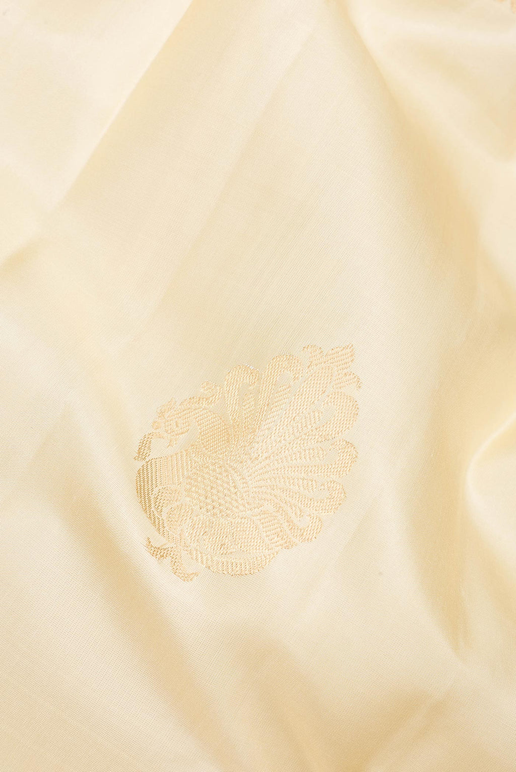 Close up of Pure Silk Cream Kanjivaram Saree with Zari Butta on the body and Zari Border.  displaying folds