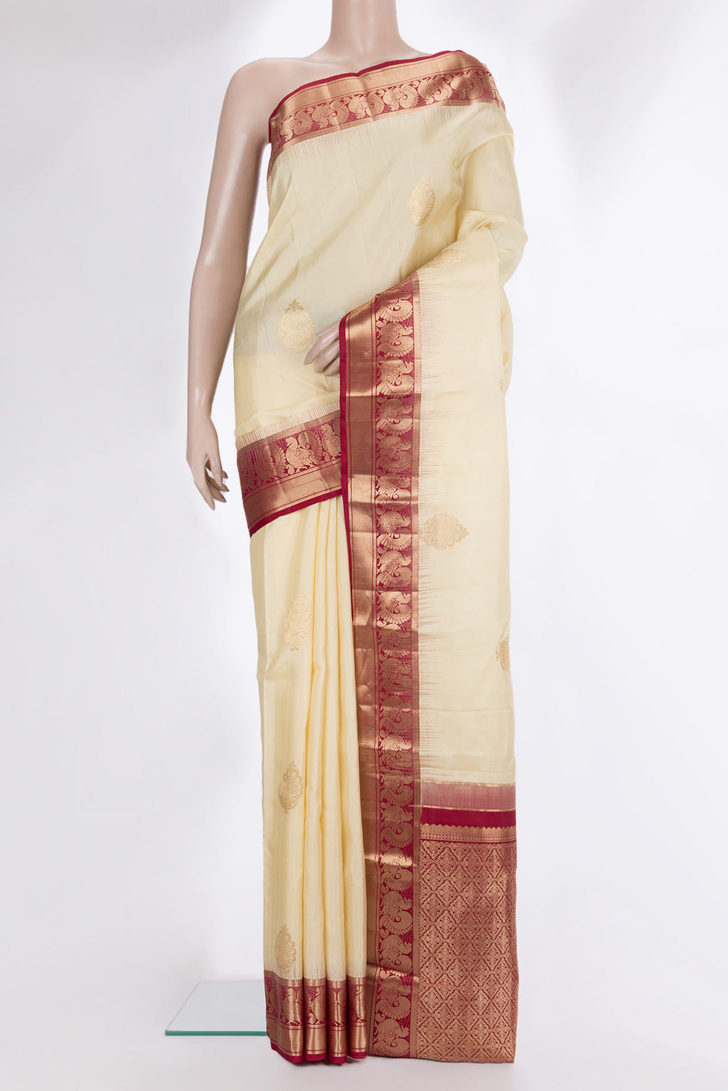 Pure Silk Cream Kanjivaram Saree with Zari Butta on the body and Zari Border.  displayed on a mannequin