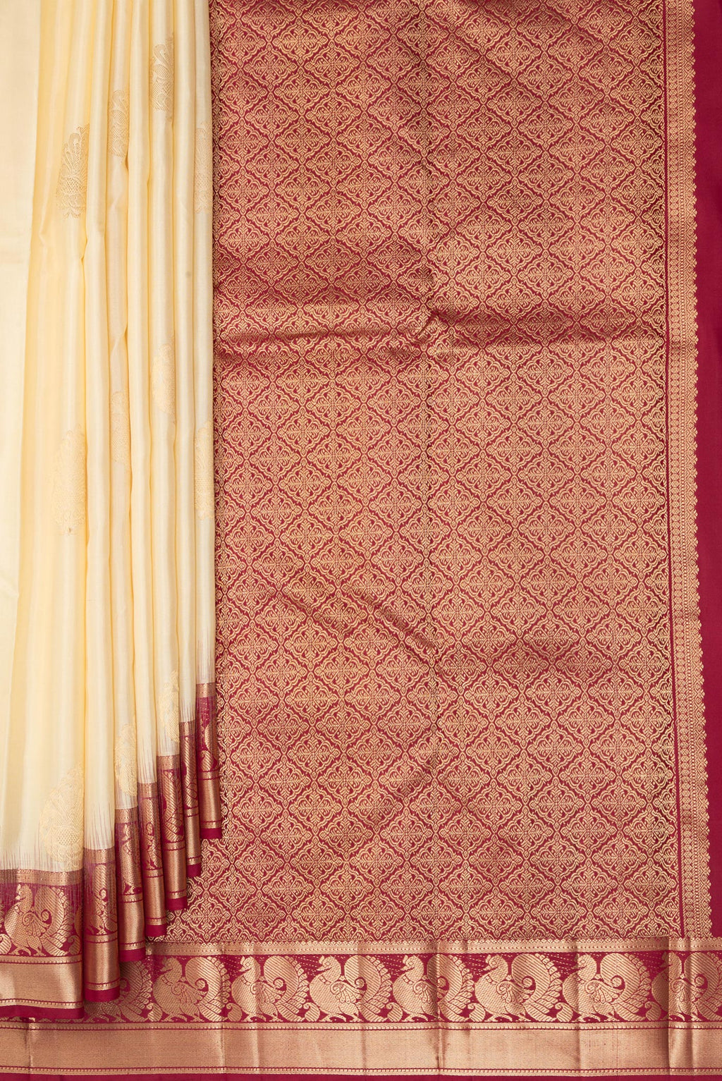 Pleats and pallu of Pure Silk Cream Kanjivaram Saree with Zari Butta on the body and Zari Border. 