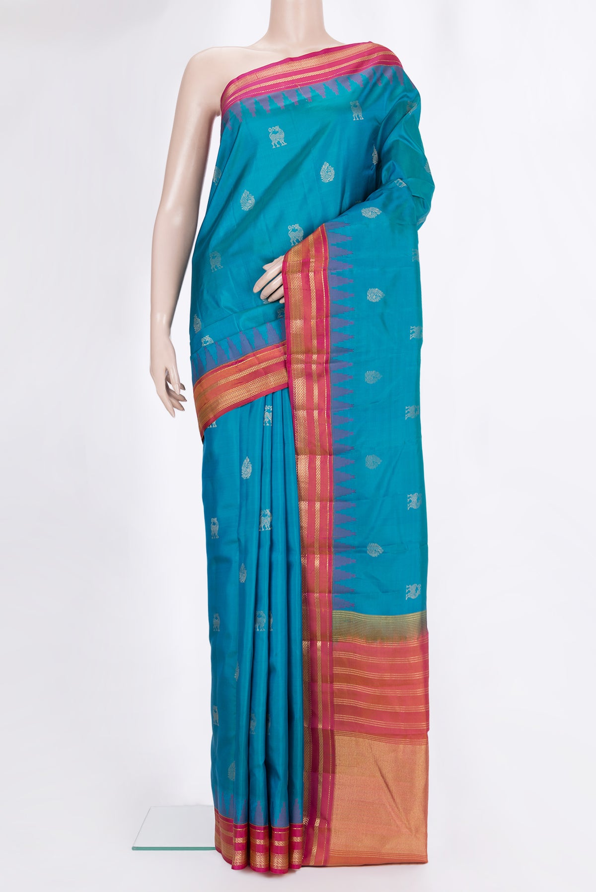 Pure Silk Peacock Blue Dual Tone Kanchipuram Saree with Zari Butta on the body and Zari Border.  displayed on a mannequin