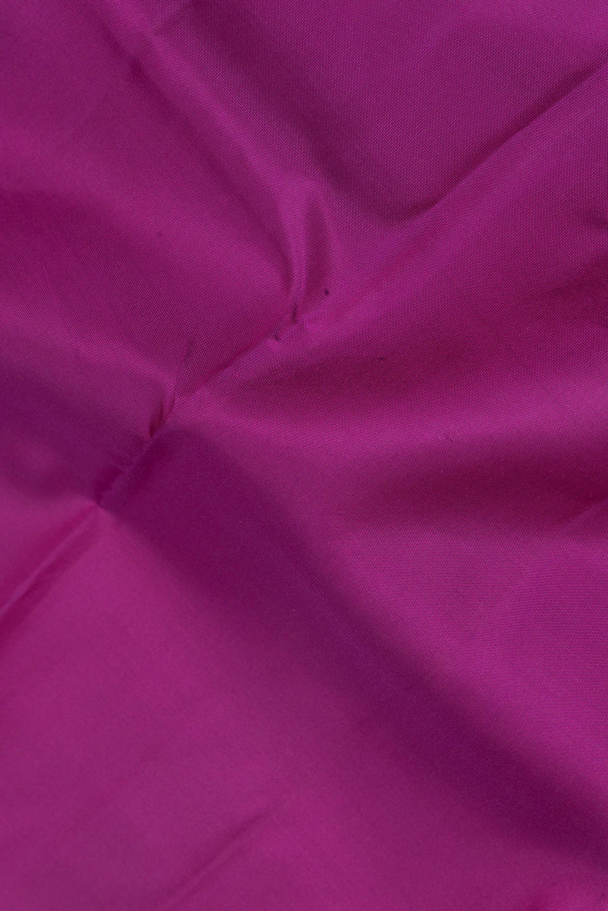 Close up of Pure Silk Magenta Kanchipuram Saree with Plain Body and Fancy Border.  displaying folds
