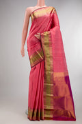 Pure Silk Coral Kanchipuram Saree with Zari Butta on the body and Zari Border.  displayed on a mannequin