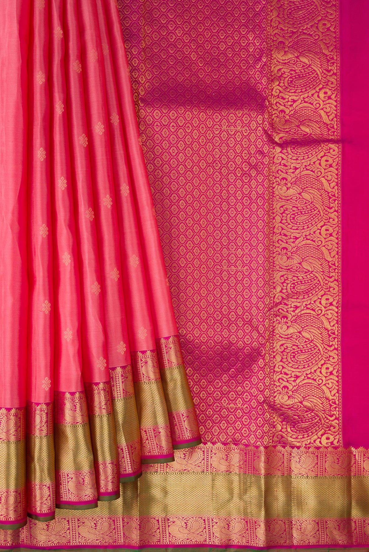 Pleats and pallu of Pure Silk Coral Kanchipuram Saree with Zari Butta on the body and Zari Border. 