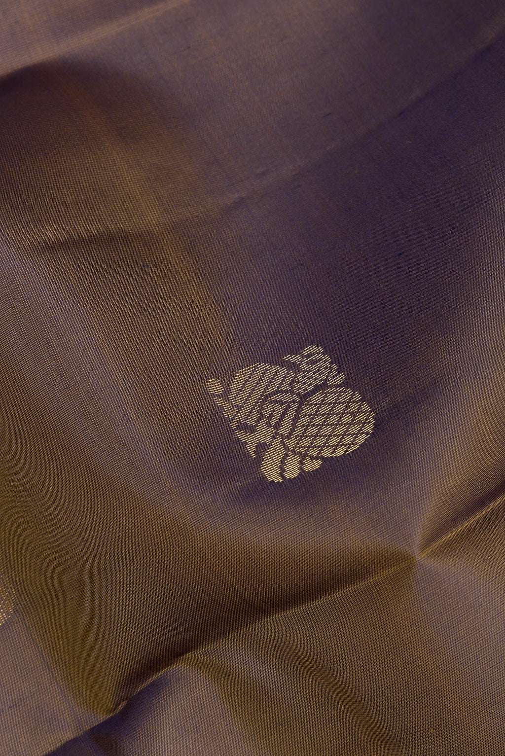 Close up of Pure Silk Mehandi Green Kanchipuram Saree with Zari Butta on the body and Zari Border.  displaying folds