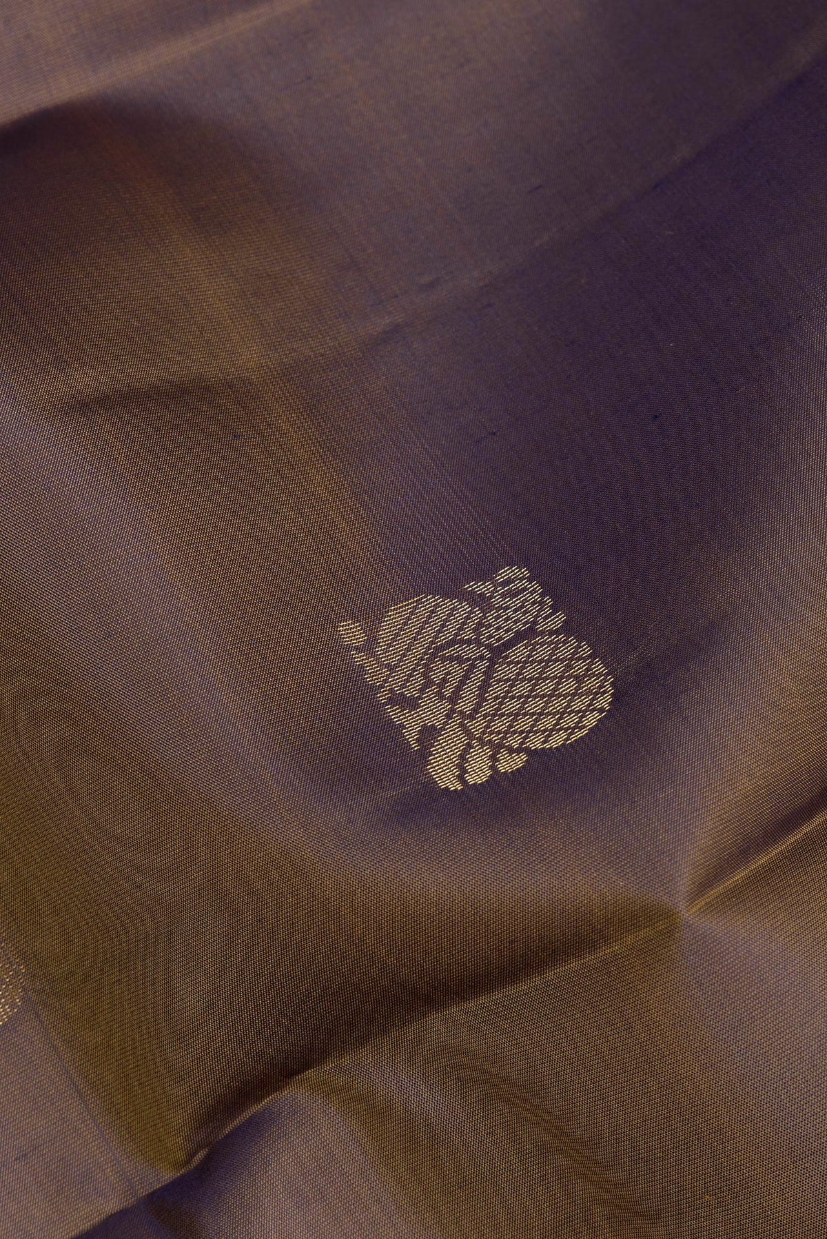 Close up of Pure Silk Mehandi Green Kanchipuram Saree with Zari Butta on the body and Zari Border.  displaying folds