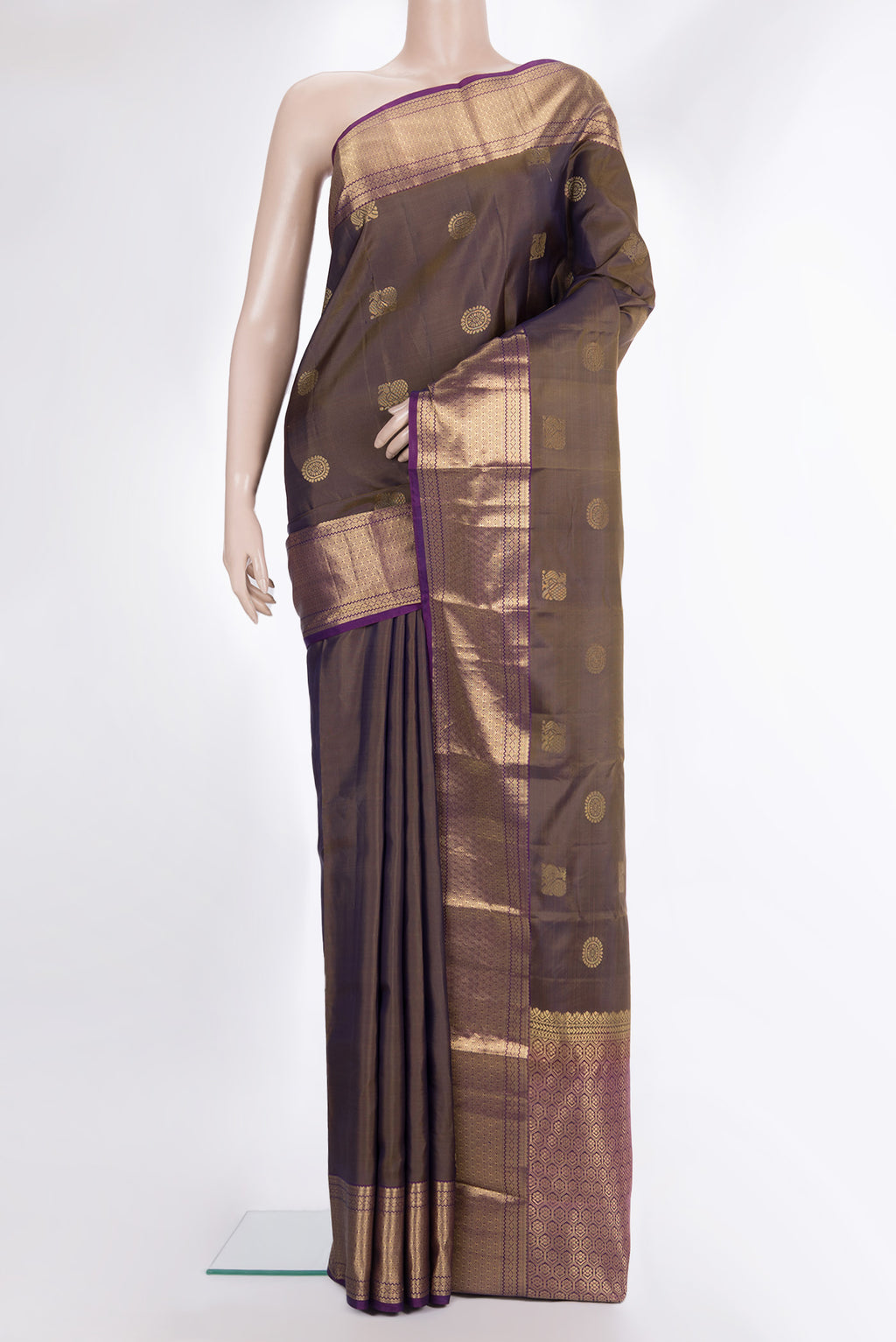 Pure Silk Mehandi Green Kanchipuram Saree with Zari Butta on the body and Zari Border.  displayed on a mannequin