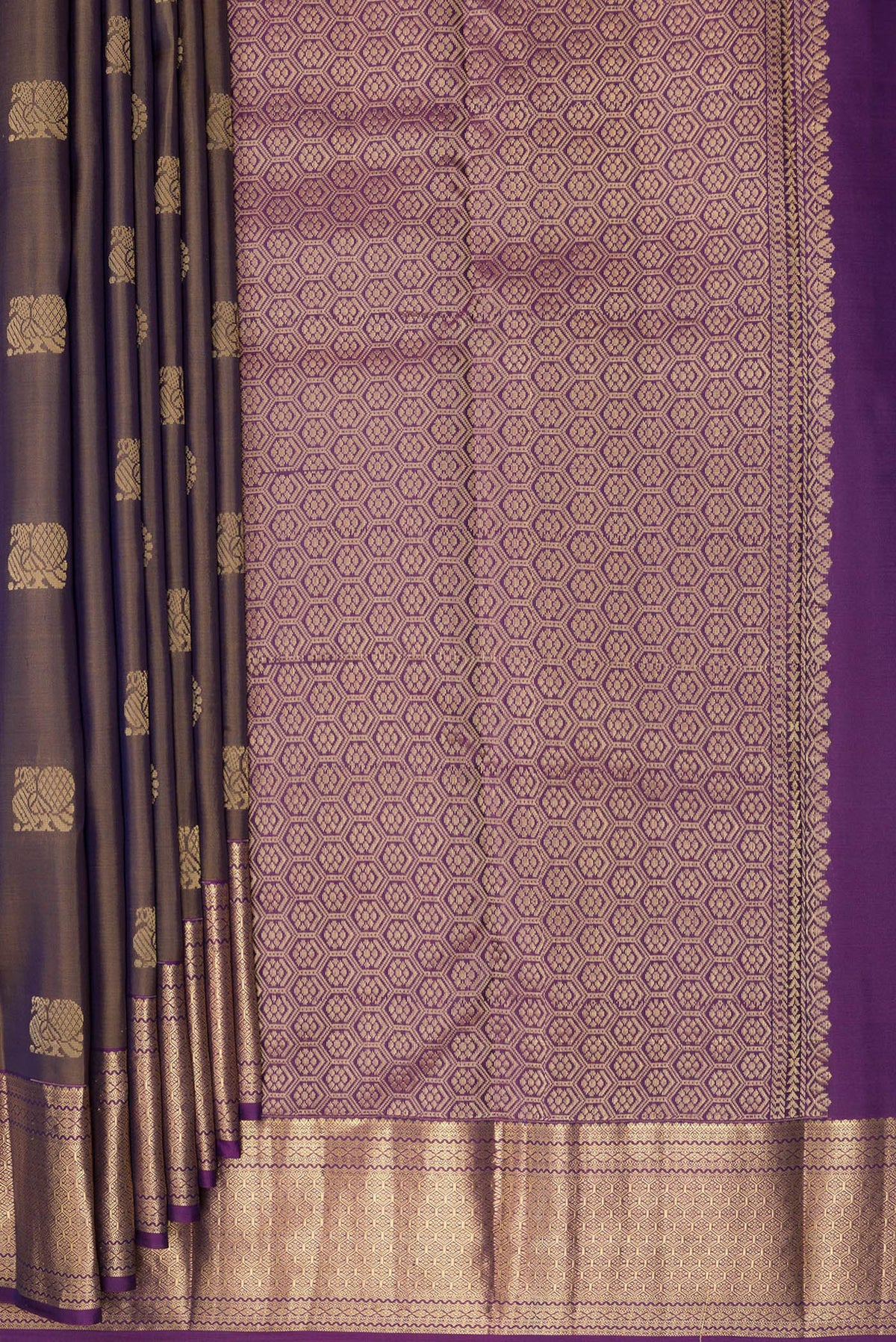 Pleats and pallu of Pure Silk Mehandi Green Kanchipuram Saree with Zari Butta on the body and Zari Border. 