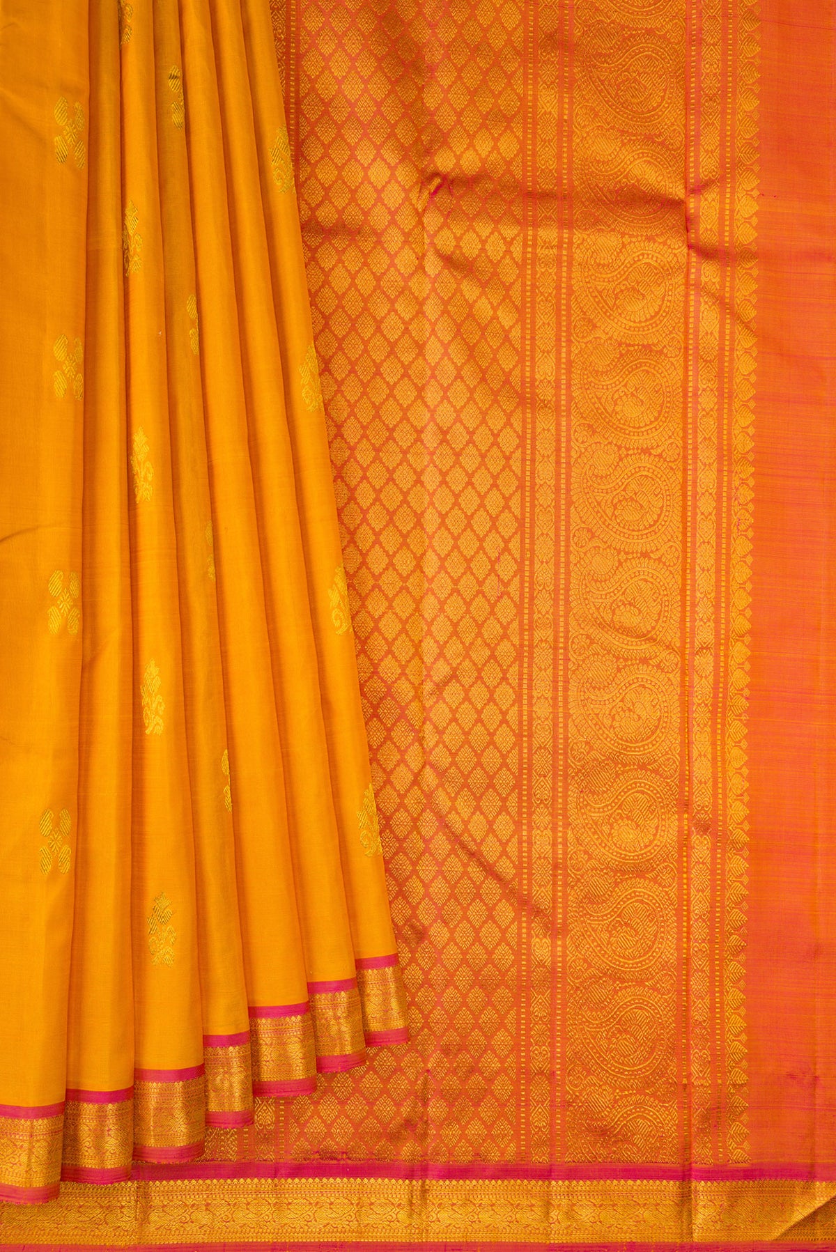 Pleats and pallu of Pure Silk Mustard Kanchipuram Saree with Zari Butta on the body and Zari Border. 