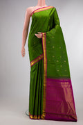Pure Silk Mehandi Green Kanchipuram Saree with Zari Butta on the body and Zari Border.  displayed on a mannequin