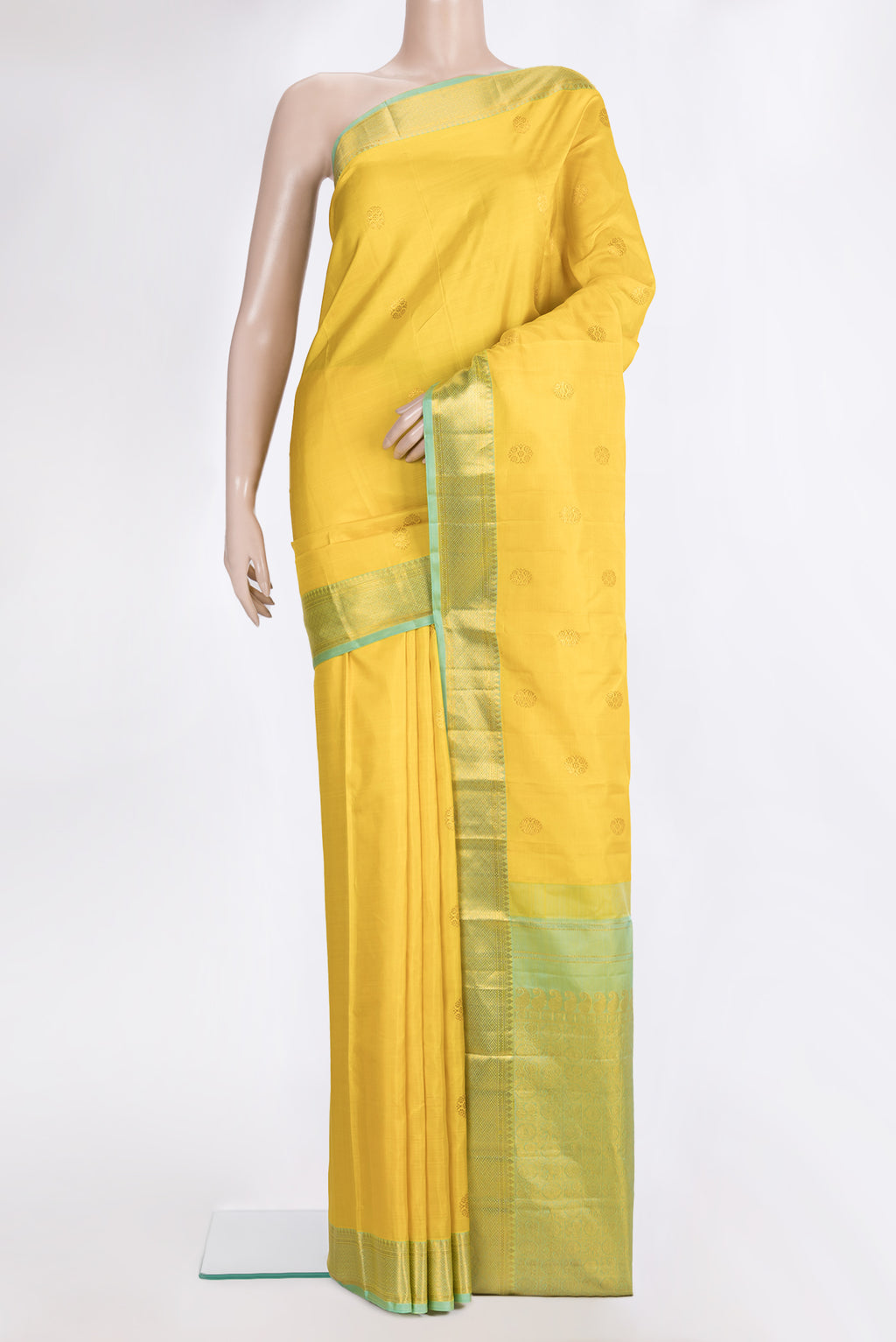 Pure Silk Yellow Kanchipuram Saree with Zari Butta on the body and Zari Border.  displayed on a mannequin