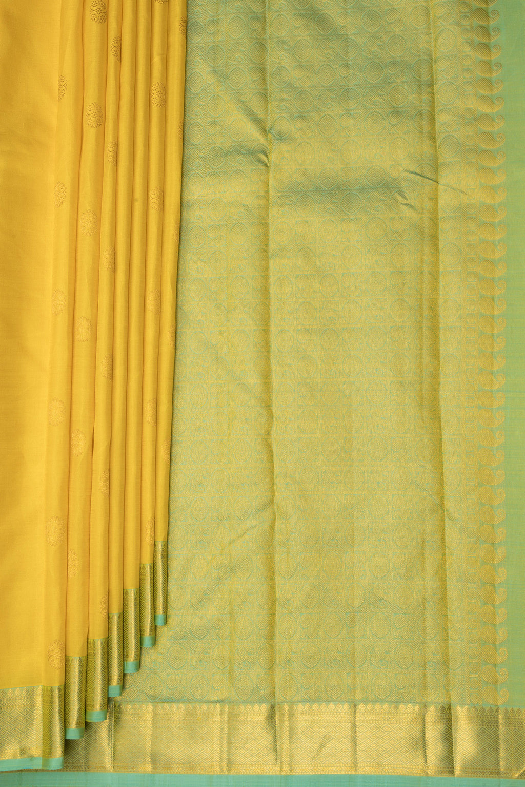 Pleats and pallu of Pure Silk Yellow Kanchipuram Saree with Zari Butta on the body and Zari Border. 