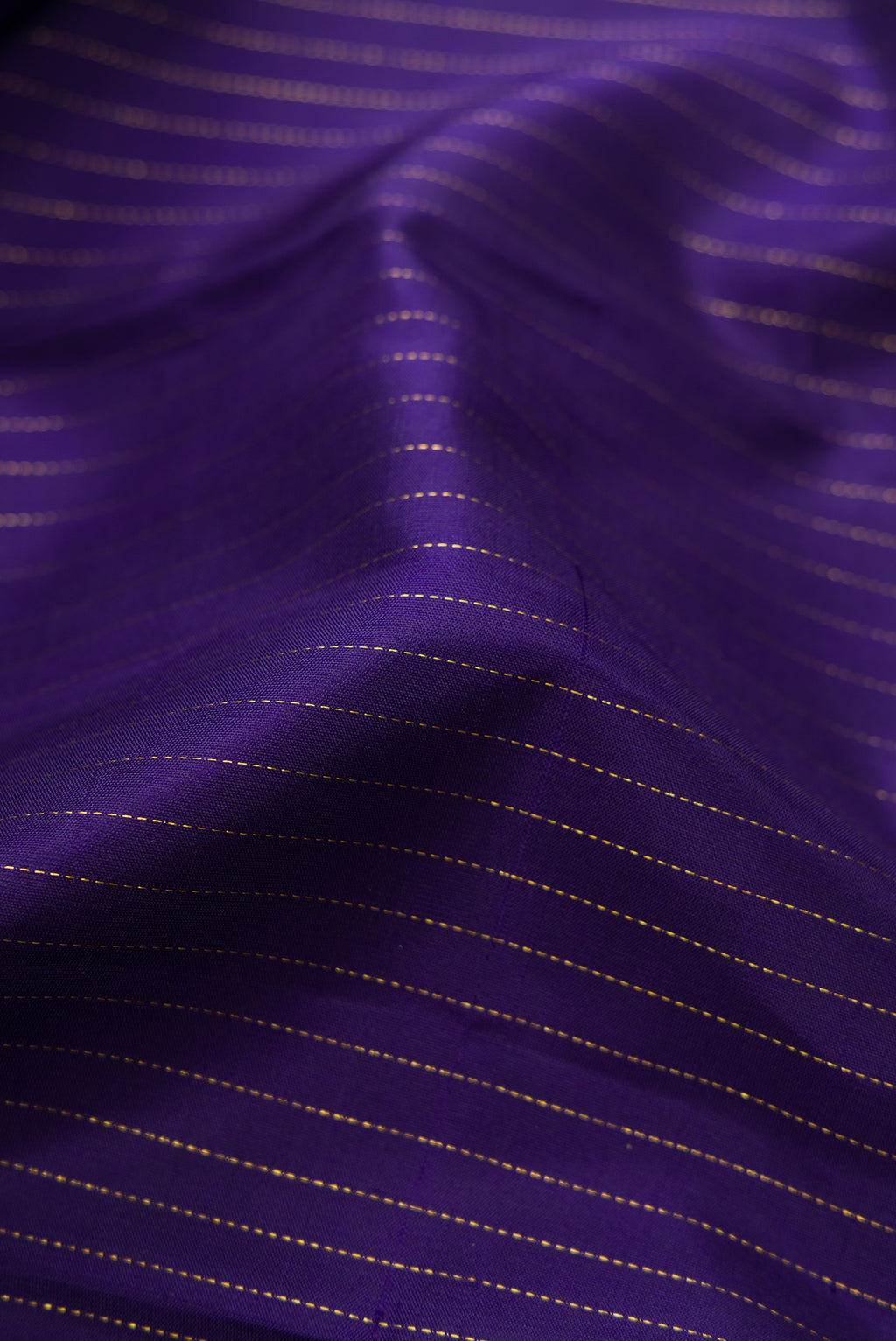 Close up of Pure Silk Navy Blue Kanjivaram Saree with Stripes on the body and Zari Border.  displaying folds