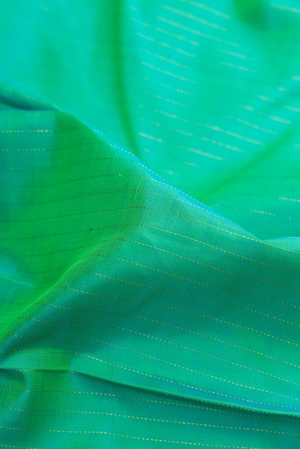 Close up of Pure Silk Sea Green Dual Tone Kanjivaram Saree with Stripes on the body and Zari Border.  displaying folds
