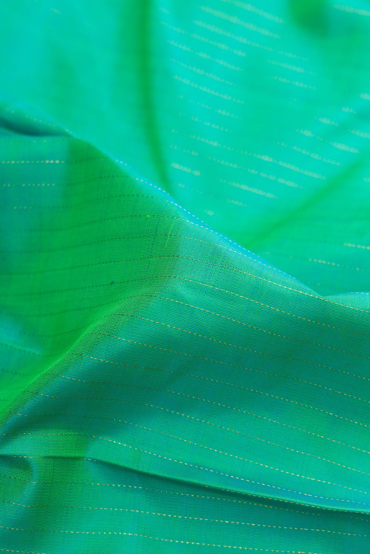Close up of Pure Silk Sea Green Dual Tone Kanjivaram Saree with Stripes on the body and Zari Border.  displaying folds