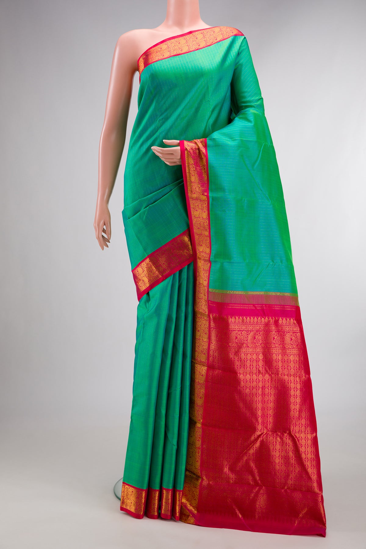 Pure Silk Sea Green Dual Tone Kanjivaram Saree with Stripes on the body and Zari Border.  displayed on a mannequin