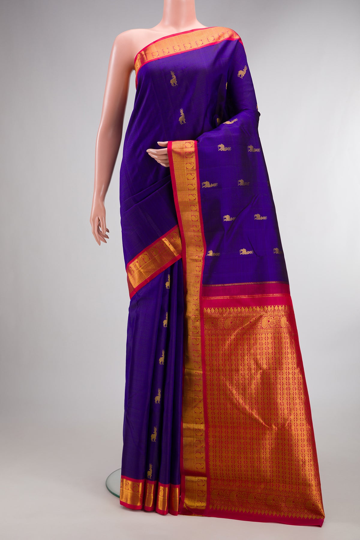 Pure Silk Royal Blue Kanjivaram Saree with Zari Butta on the body and Zari Border.  displayed on a mannequin