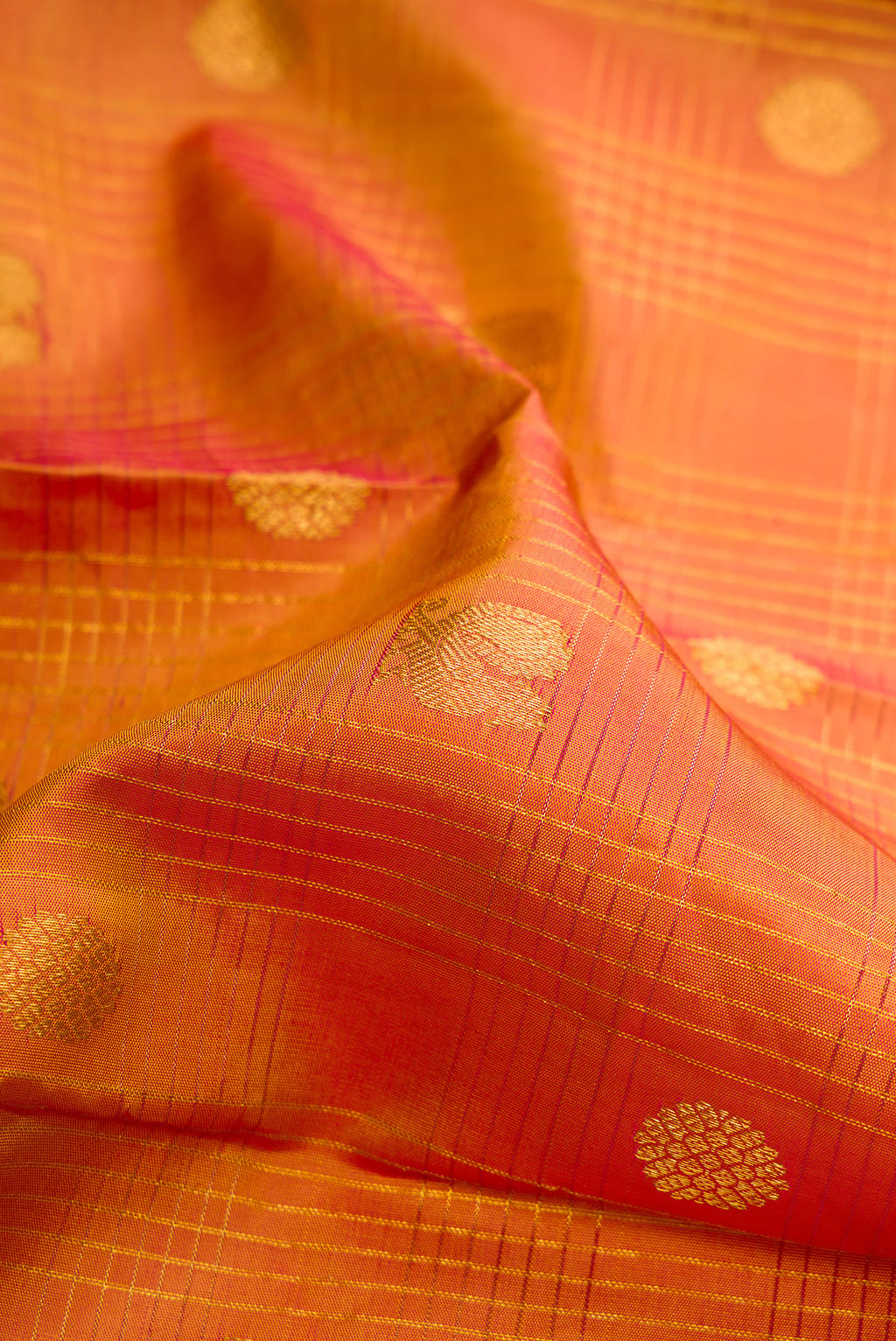 Close up of Pure Silk Mustard Kanjivaram Saree with Checked design on the body and Zari Border.  displaying folds