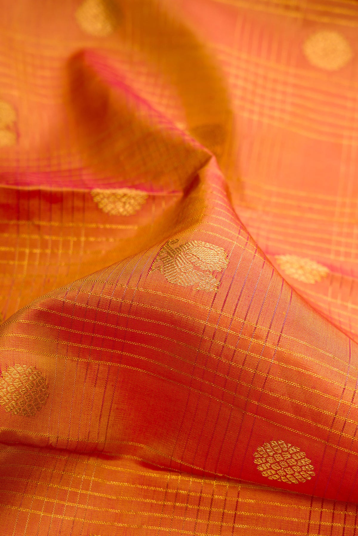 Close up of Pure Silk Mustard Kanjivaram Saree with Checked design on the body and Zari Border.  displaying folds