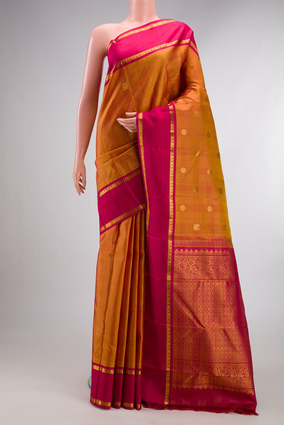 Pure Silk Mustard Kanjivaram Saree with Checked design on the body and Zari Border.  displayed on a mannequin